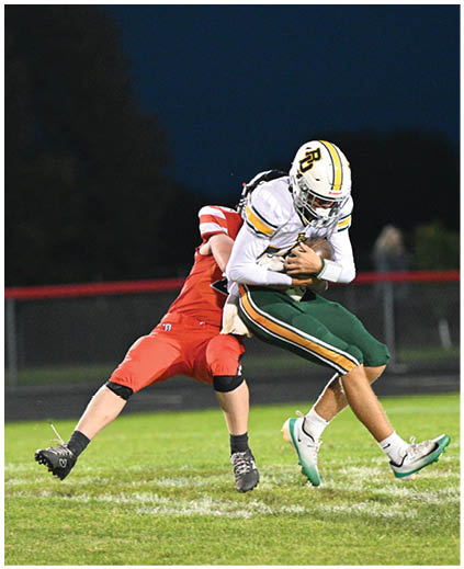 Two football players are tackling each other. Description generated by AI