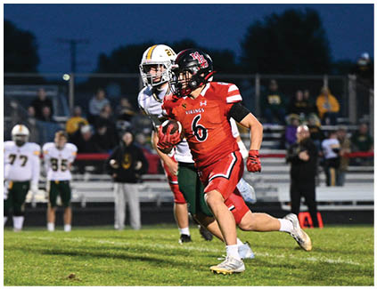 A football player running on the field. Description generated by AI