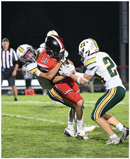 Two football players are fighting for the ball. Description generated by AI