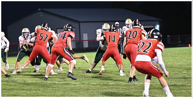 A group of football players in red jerseys are running on the field. Description generated by AI