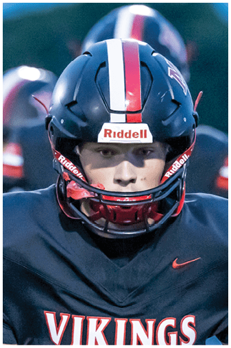 Two football players wearing black and white uniforms. Description generated by AI