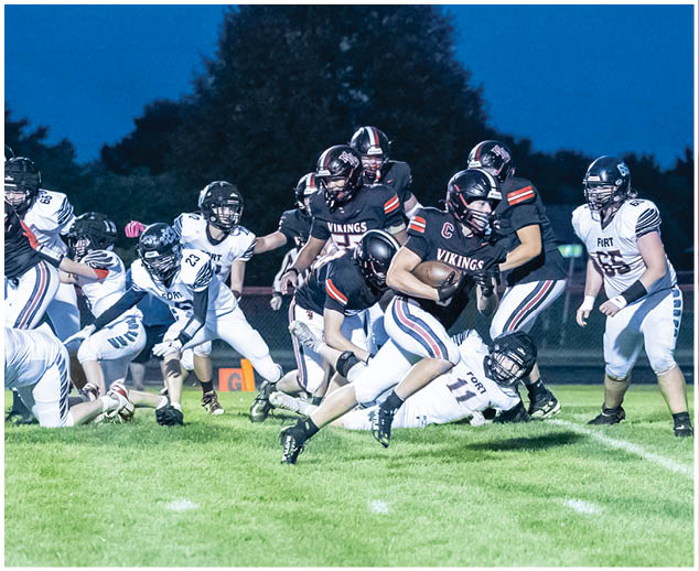 A group of football players on a field. Description generated by AI