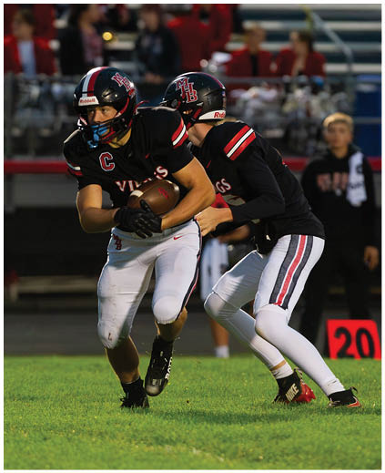 A football player is running with the ball. Description generated by AI