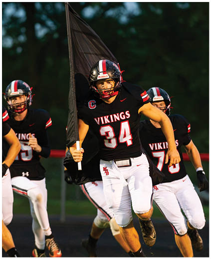 A football player in a white jersey with the number 90 on it. Description generated by AI