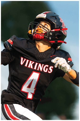 Two football players on a field. Description generated by AI