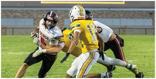 A football player in a black jersey is running with the ball. Description generated by AI