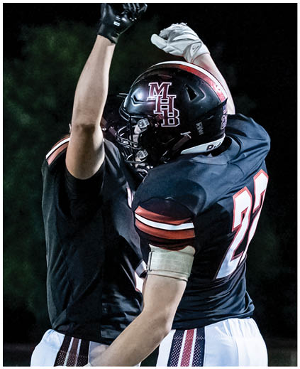 A football player wearing a white jersey with the number 7 on it. Description generated by AI