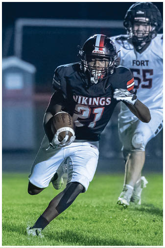 A football player wearing a helmet and jersey with the number 44. Description generated by AI