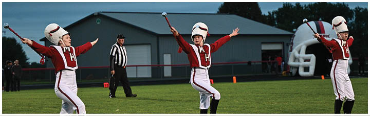 A football player in a white jersey catching a ball. Description generated by AI