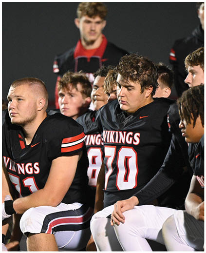 A football player wearing a white jersey with the number 7 on it. Description generated by AI