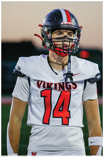 A football player in a black jersey with the number 6 on it. Description generated by AI