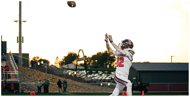 A football player wearing a white jersey with the number 3 on it. Description generated by AI
