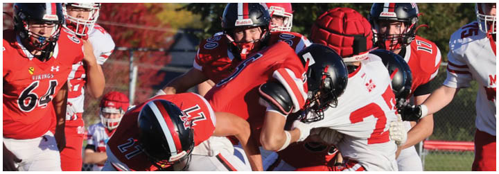 A group of football players on a field. Description generated by AI