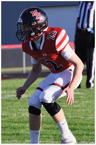 A football player wearing a black and white jersey with the number 5 on it. Description generated by AI