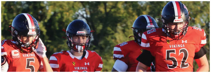 A group of football players in a game. Description generated by AI
