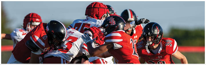 A group of football players on a field. Description generated by AI