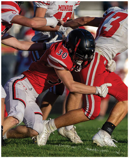A football player in a white jersey with the number 90 on it. Description generated by AI