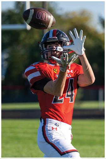 Two football players on a field. Description generated by AI