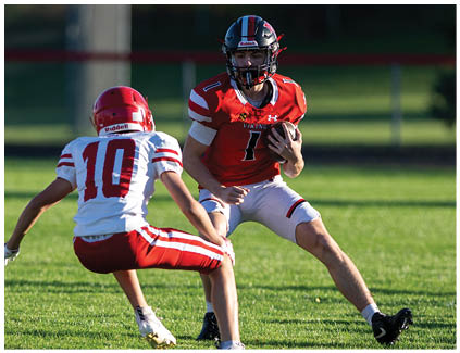 A football player in a yellow jersey is running with the ball. Description generated by AI