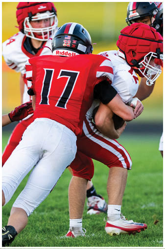 A football player wearing a black and white jersey with the number 5 on it. Description generated by AI