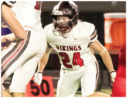 Two football players wearing black and white uniforms. Description generated by AI