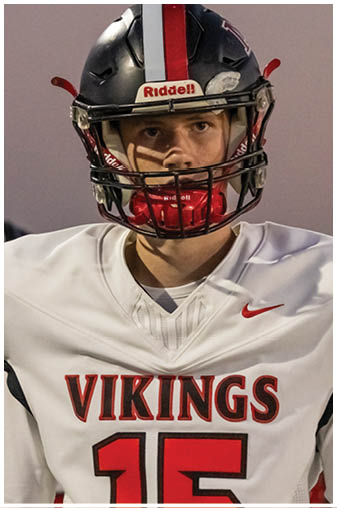 A football player in a black jersey with the number 6 on it. Description generated by AI
