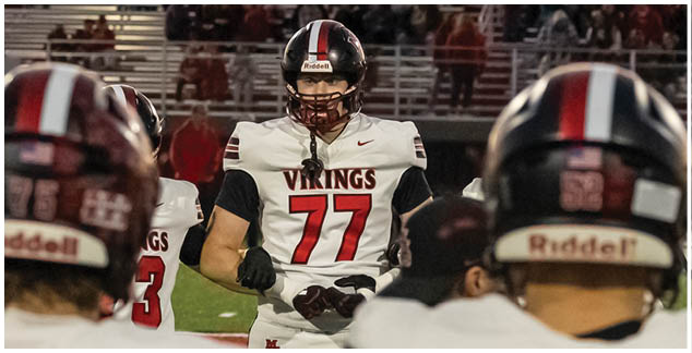A football player in a white jersey with the number 4 on it. Description generated by AI