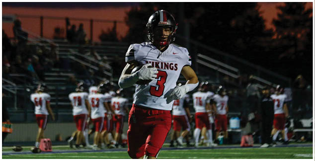 A football player in a white jersey with the number 4 on it. Description generated by AI