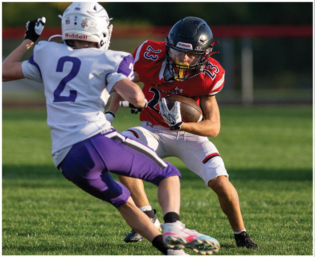 A football player in a white jersey with the number 10 on it. Description generated by AI