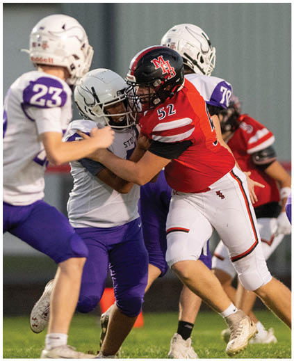 A football player in a white jersey with the number 90 on it. Description generated by AI