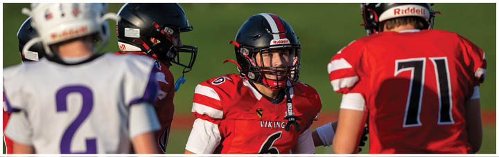 A group of football players on a field. Description generated by AI
