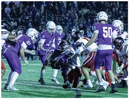 Two football players wearing black and white uniforms. Description generated by AI
