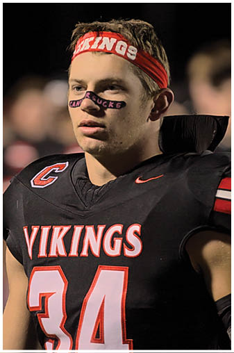 A group of football players on a field. Description generated by AI