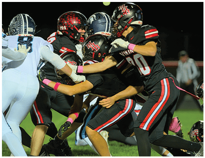 Two football players wearing black and white uniforms. Description generated by AI