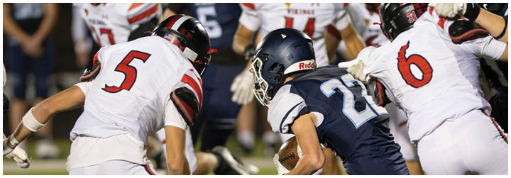 A group of football players in a game. Description generated by AI