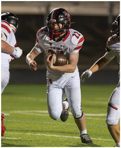 A football player in a white jersey with the number 90 on it. Description generated by AI
