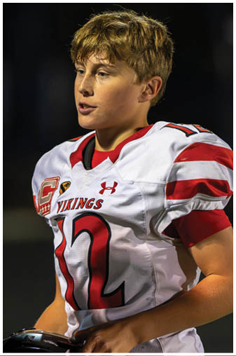 Two football players on a field. Description generated by AI