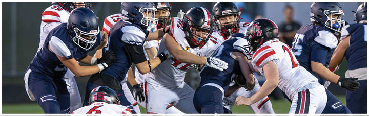 A group of football players on a field. Description generated by AI