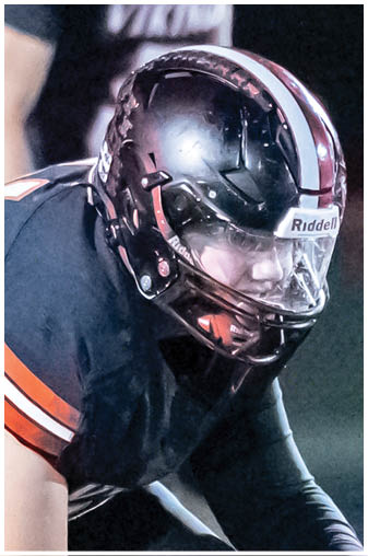 A football player in a black jersey with the number 6 on it. Description generated by AI