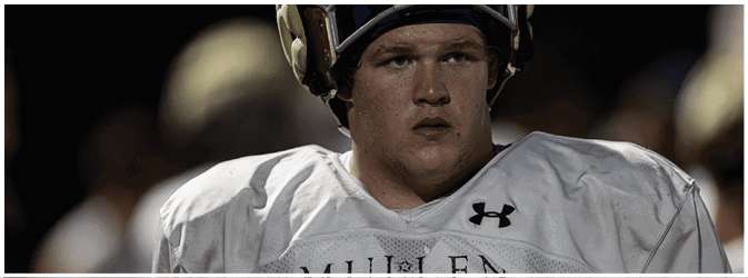 A person wearing a white football jersey and helmet looks focused during a nighttime game. Description generated by AI