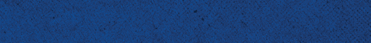 A close-up of a textured blue surface with small black specks scattered throughout. Description generated by AI