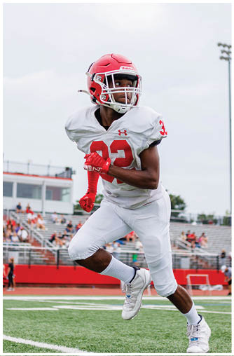 A football player running on the field. Description generated by AI