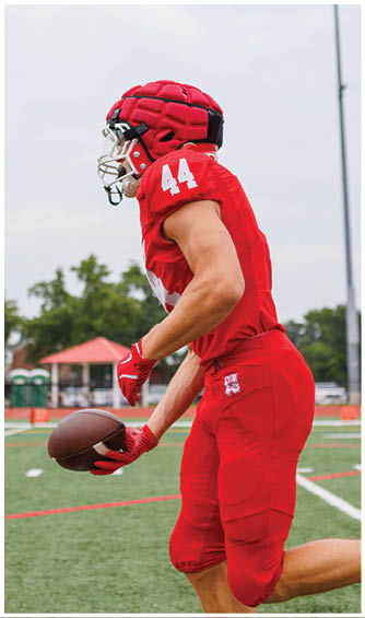 A football player running on the field. Description generated by AI
