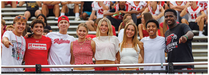 A group of football players on a field. Description generated by AI