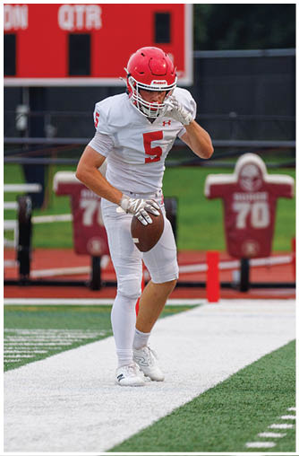 A football player running on the field. Description generated by AI