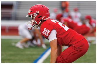 A football player running on the field. Description generated by AI