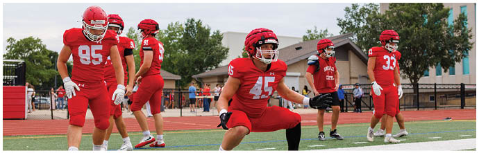 A football player is sliding on the ground. Description generated by AI