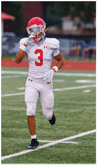 A football player running on the field. Description generated by AI