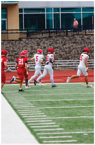 A football player running on the field. Description generated by AI