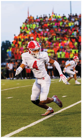 A football player running on the field. Description generated by AI